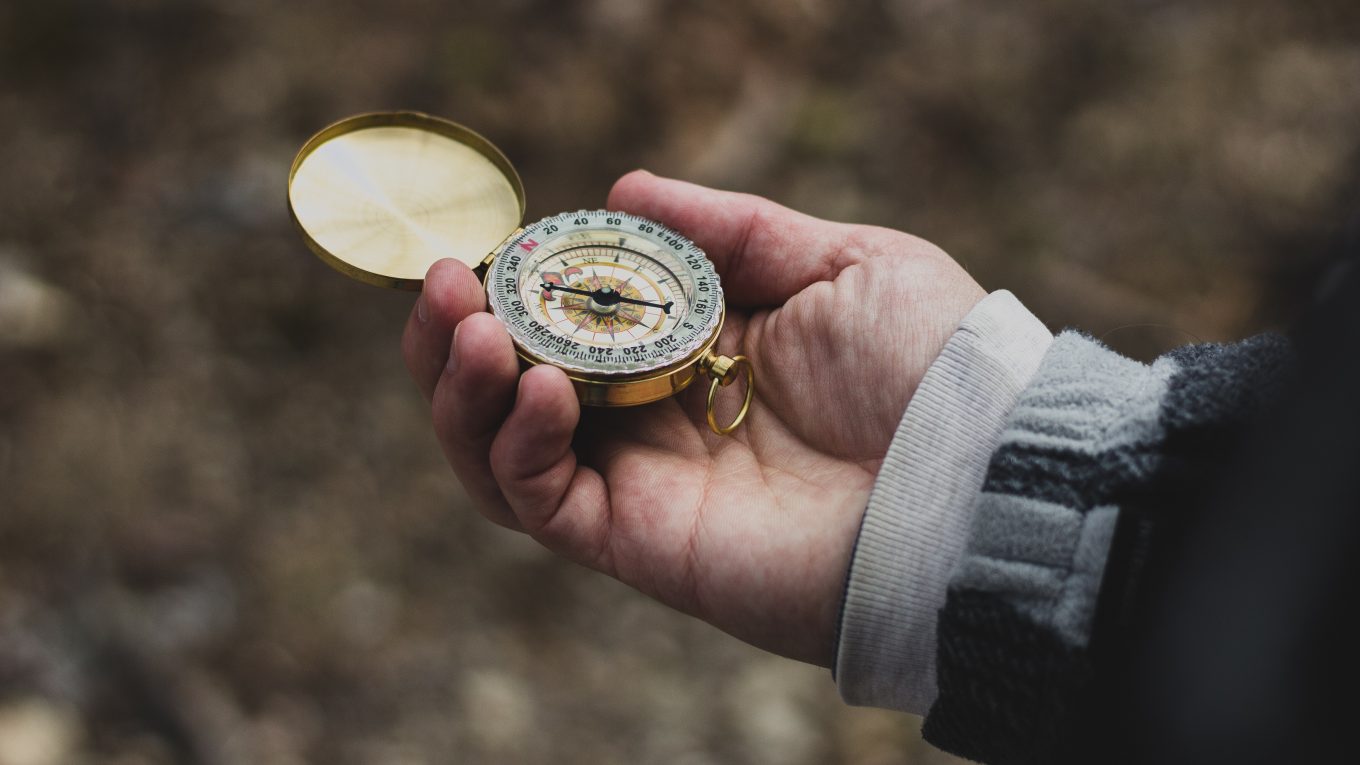 person holding an open compass