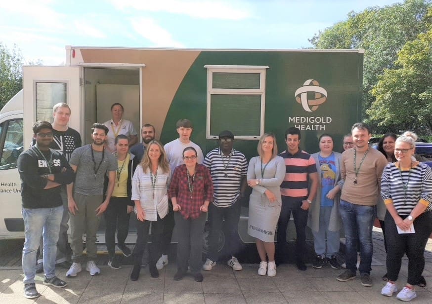 medigold team outside mobile medigold van