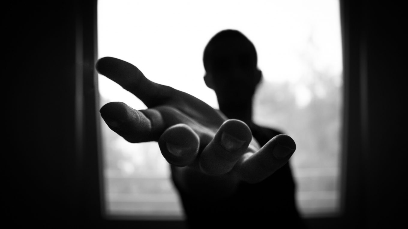 black and white image of someone extending a hand