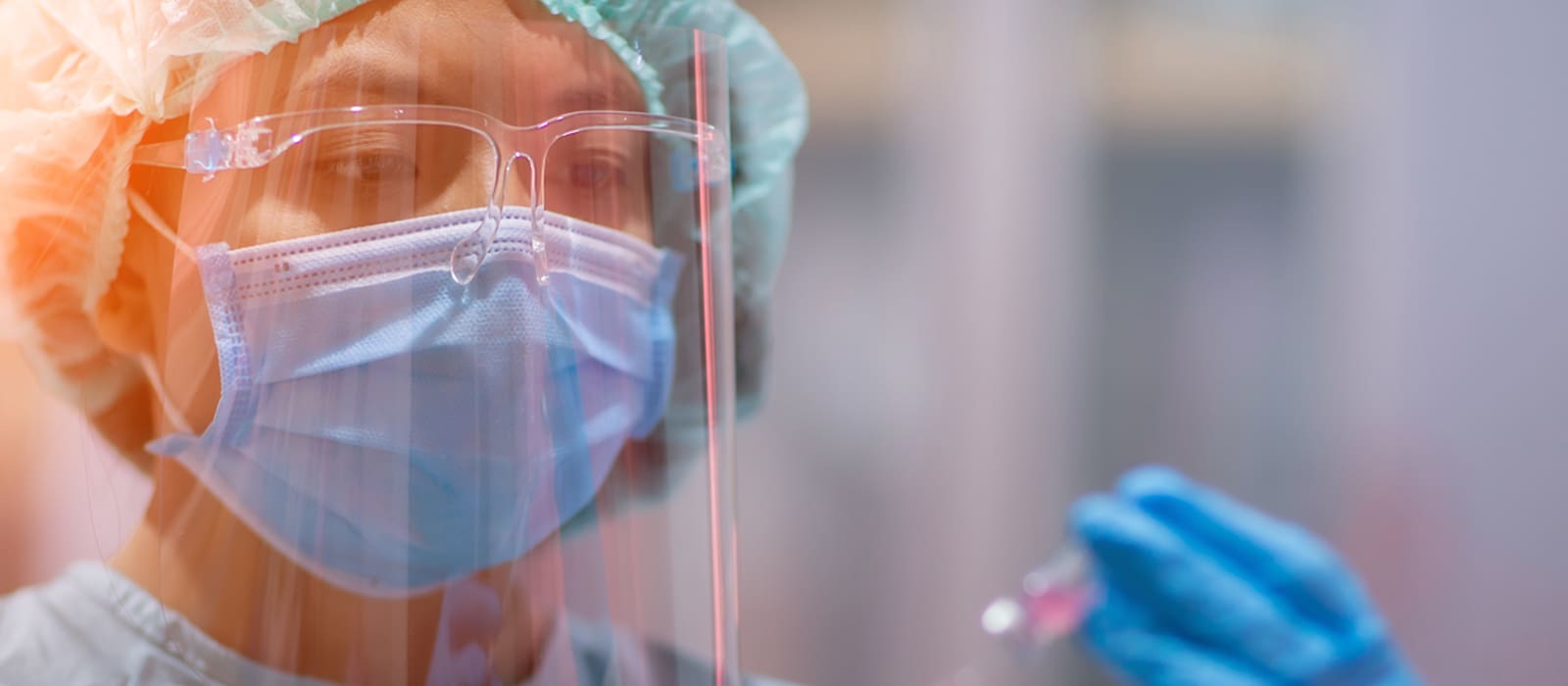 COVID Testing services - nurse inspecting a vial