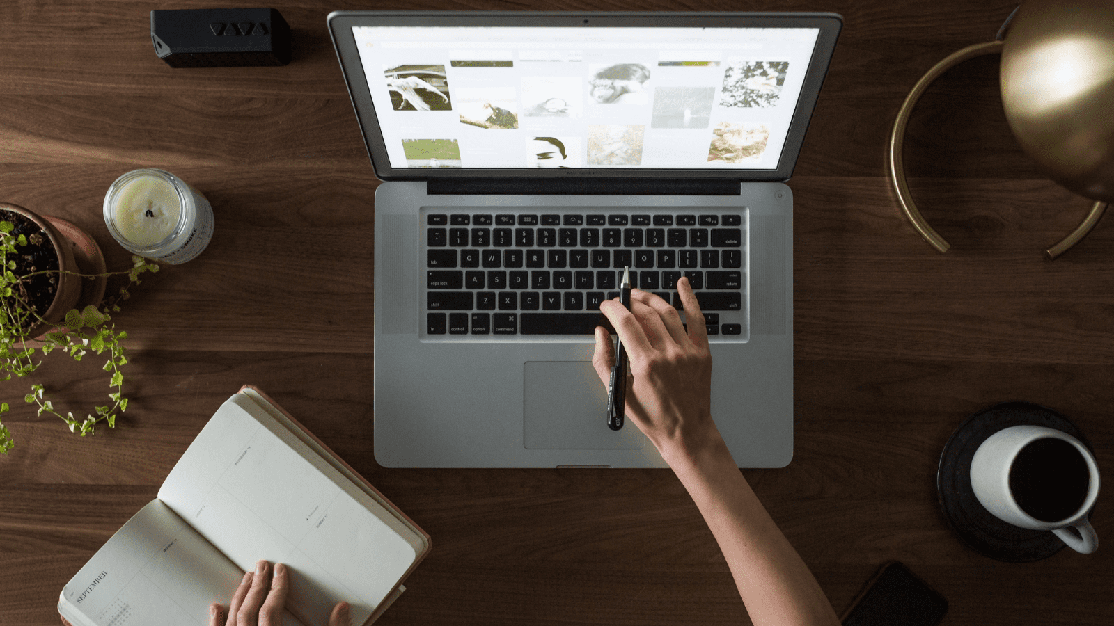 person working at a desk on a macbook