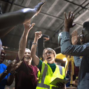 Group of employees celebrating an achievement at work.