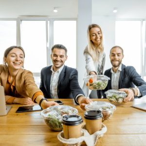 Group of people in an office grabbing a healthy lunch and coffee. 