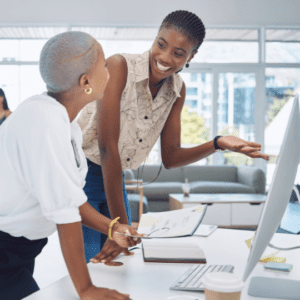 Women showing another women something on the computer 